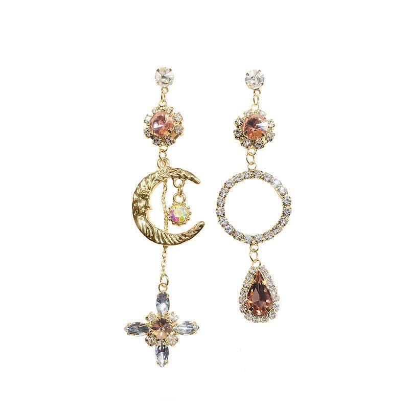 Asymmetric long earrings featuring a sun and moon design, embellished with sparkling rhinestones, showcasing elegance and style.