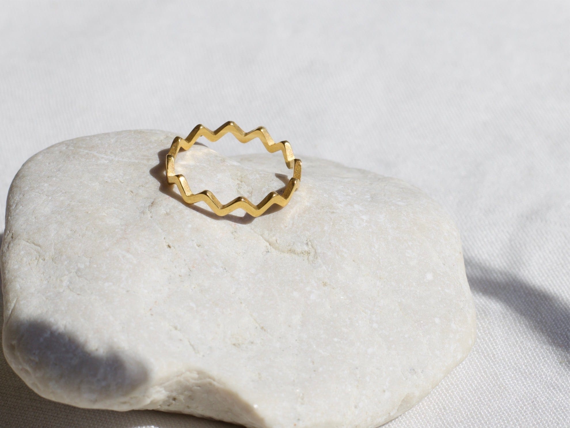 Atticus Dainty ZigZag Stacking Ring in gold, showcasing its minimalist geometric design and elegant finish.