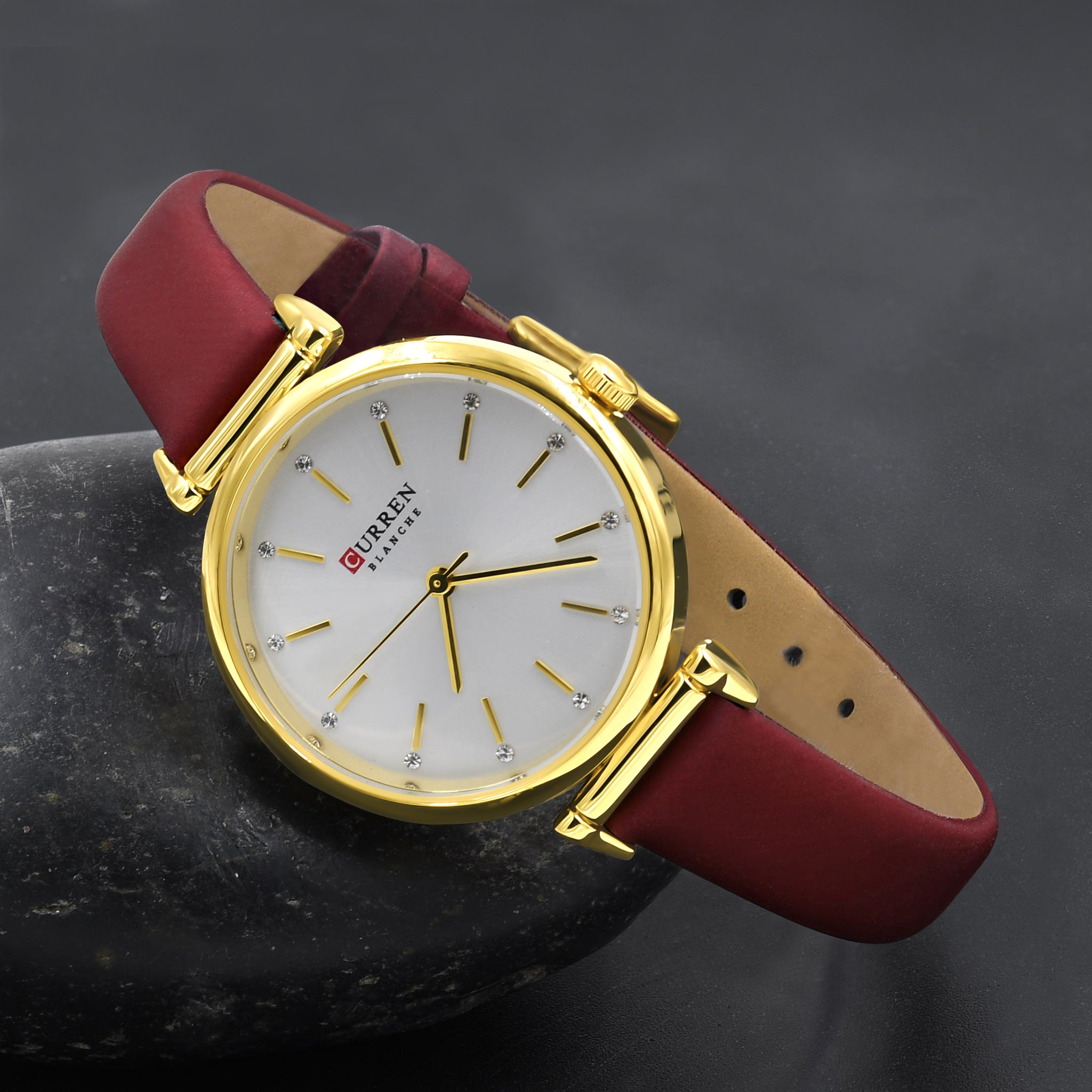 AUDIRE Curren Women Watch featuring a round metal dial with crystal hour markers and a sleek leather band, showcasing elegance and durability.