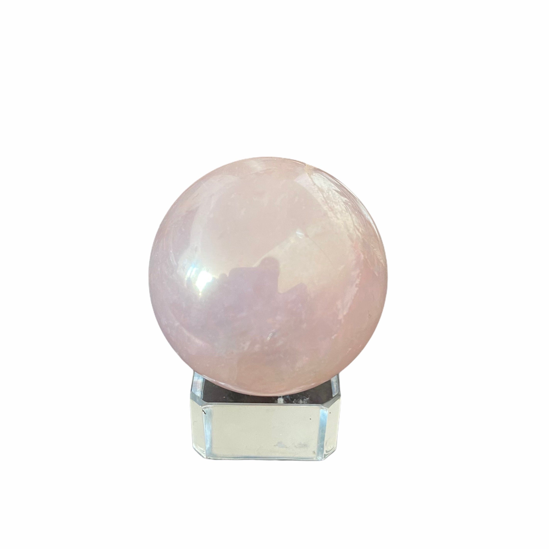 Aura Rose Quartz Sphere on a glass stand, showcasing its soft pink color and smooth surface, symbolizing love and harmony.