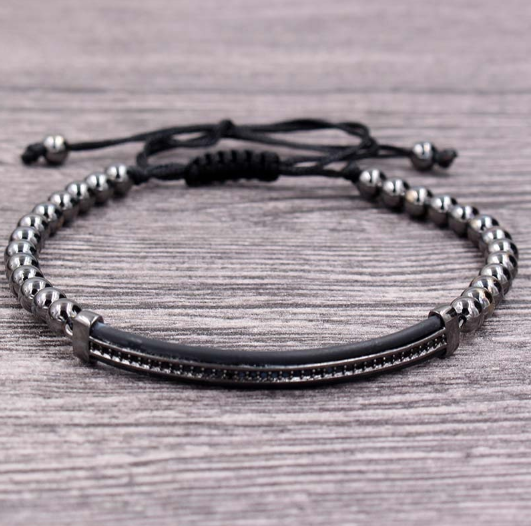 Aureate Steel Bracelet featuring golden beads and a sleek black band, elegantly designed for versatile wear.