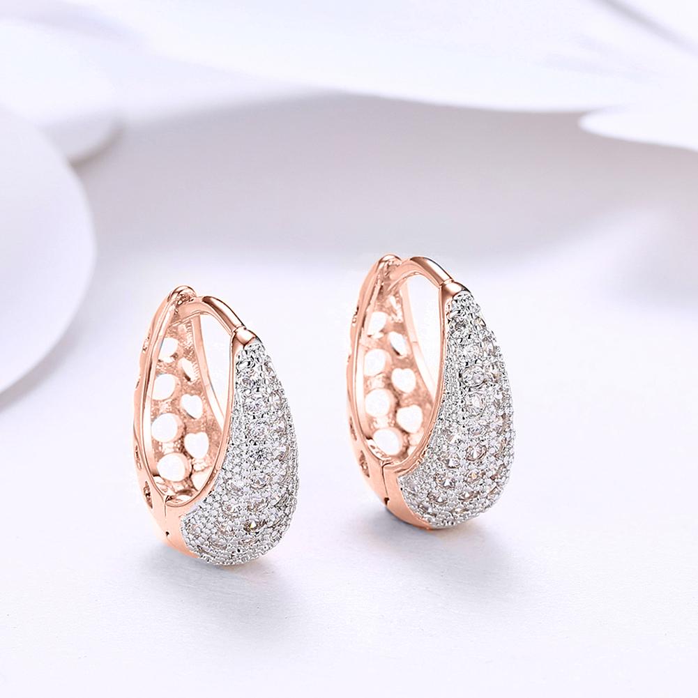 Austrian Crystal Micro-Pav'e Pear Shaped Teardrop Huggies in 18K gold plating, showcasing their elegant design and sparkling crystals.