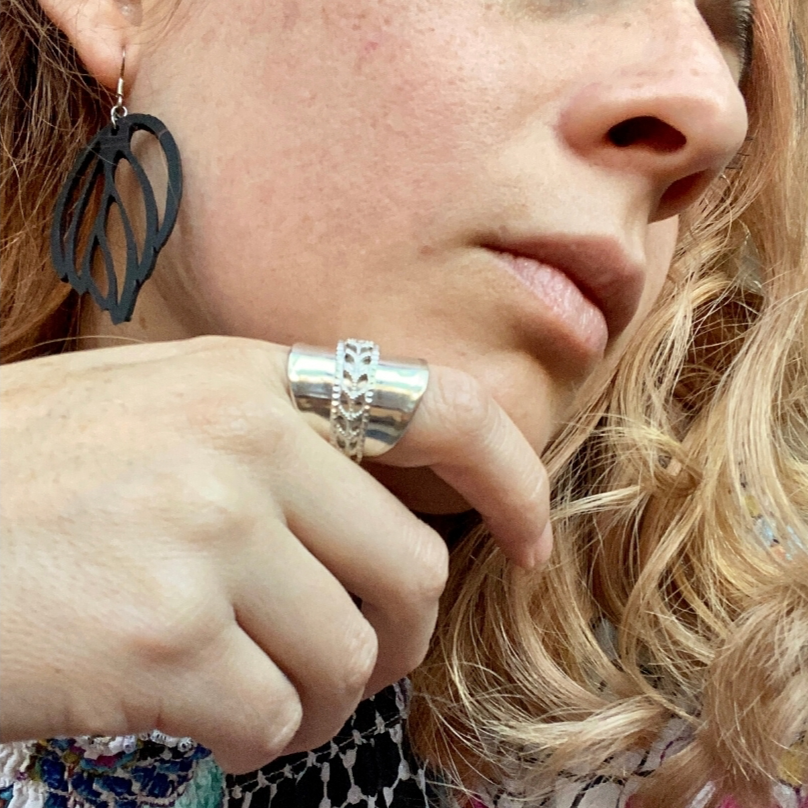 A pair of Autumn Recycled Rubber Earrings, handcrafted from reclaimed tyre inner tubes, featuring unique textures and a design inspired by autumn leaves.