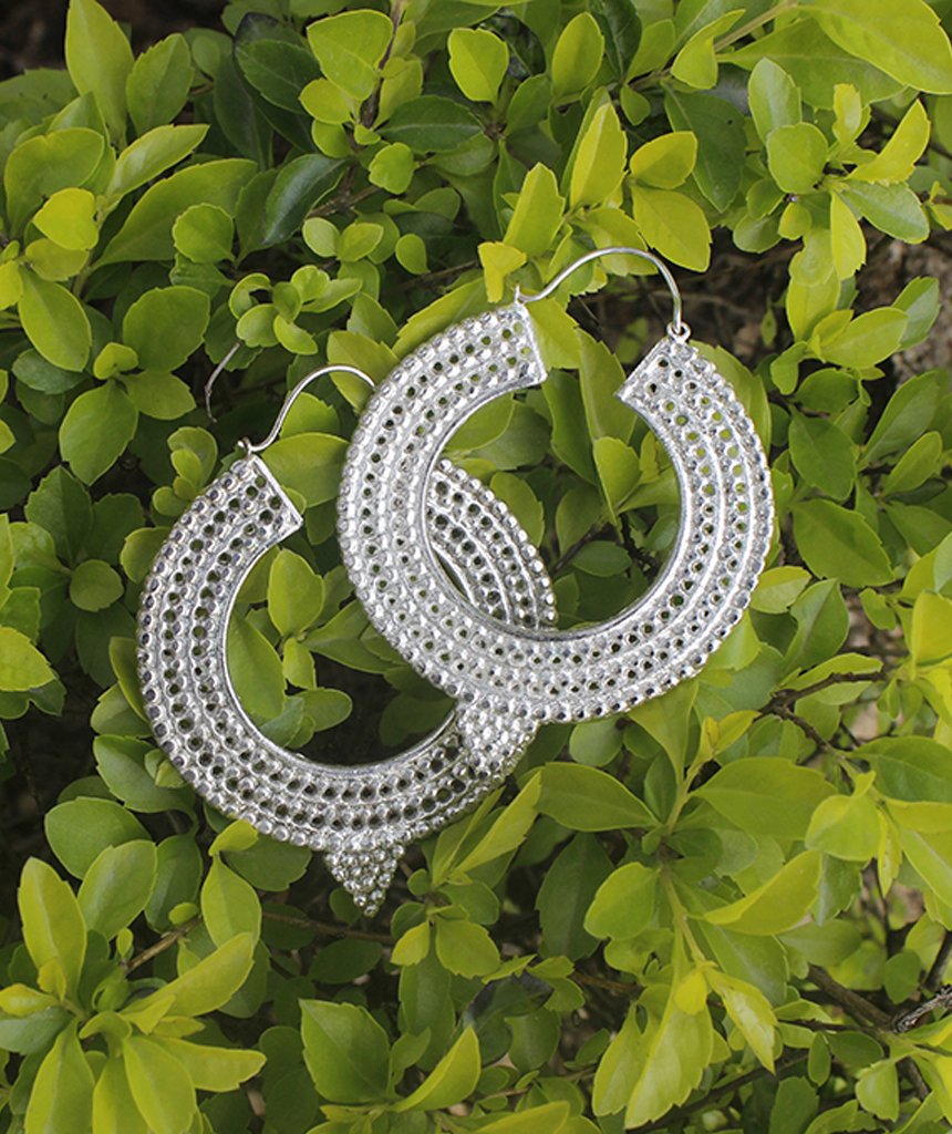 A pair of Aztec Hoop Earrings featuring intricate brass designs, available in three sizes, perfect for sensitive skin.