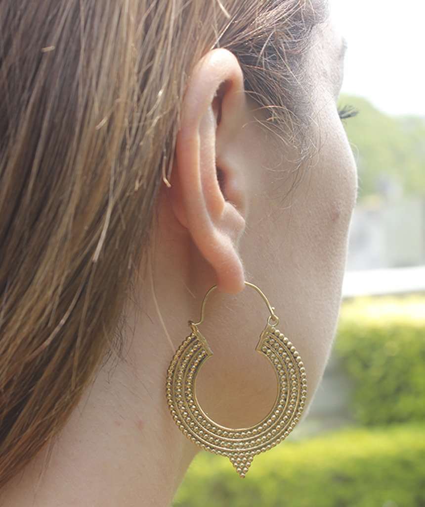 A pair of Aztec Hoop Earrings featuring intricate brass designs, available in three sizes, perfect for sensitive skin.