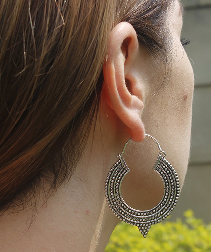 A pair of Aztec Hoop Earrings featuring intricate brass designs, available in three sizes, perfect for sensitive skin.