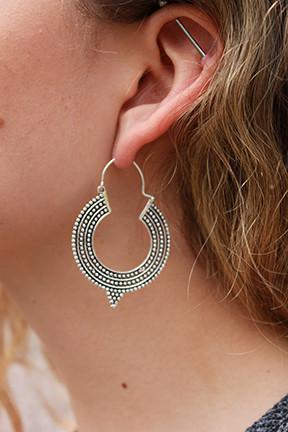 A pair of Aztec Hoop Earrings featuring intricate brass designs, available in three sizes, perfect for sensitive skin.