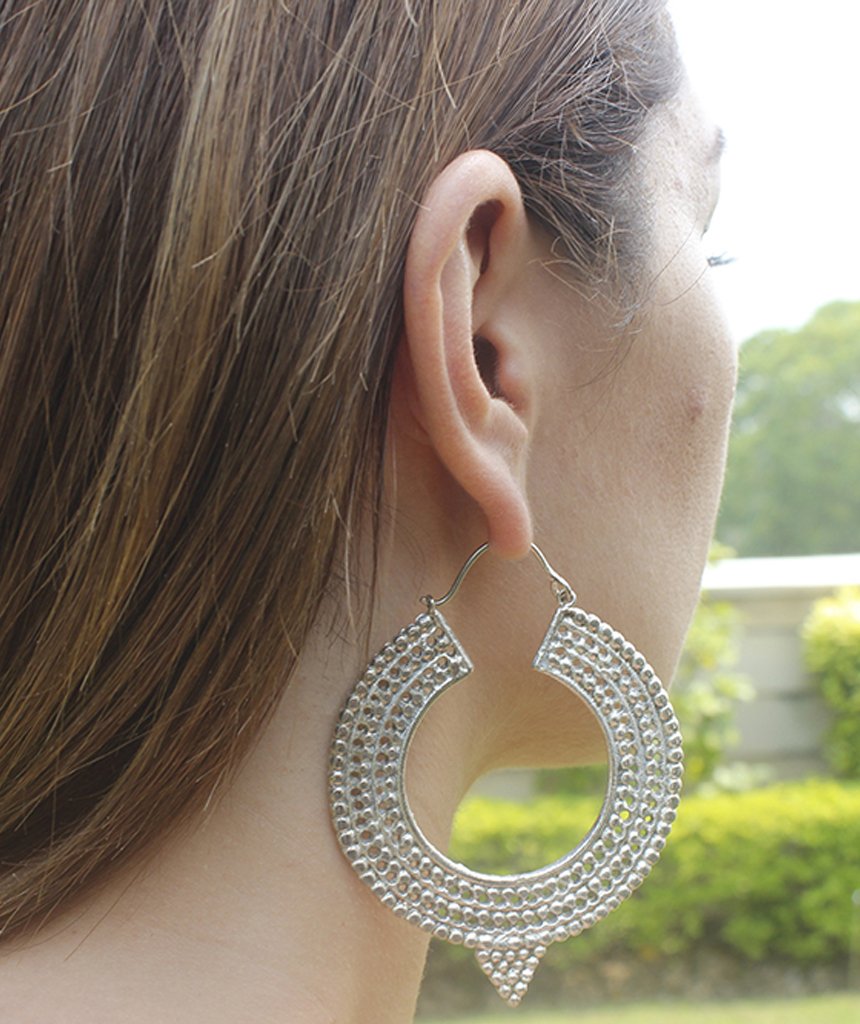 A pair of Aztec Hoop Earrings featuring intricate brass designs, available in three sizes, perfect for sensitive skin.