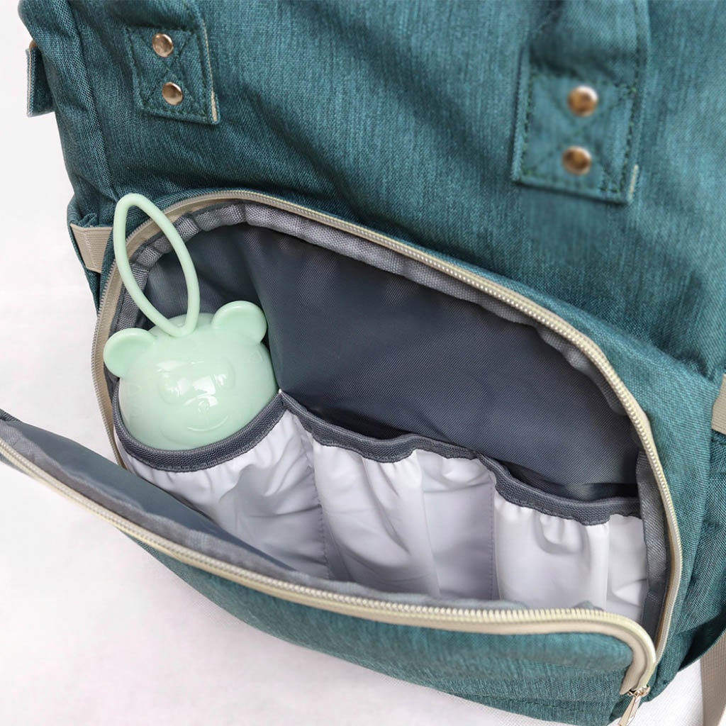 A stylish Baby Crib Backpack showcasing its multi-functional design, featuring a diaper compartment, insulated bottle pocket, and crib setup.