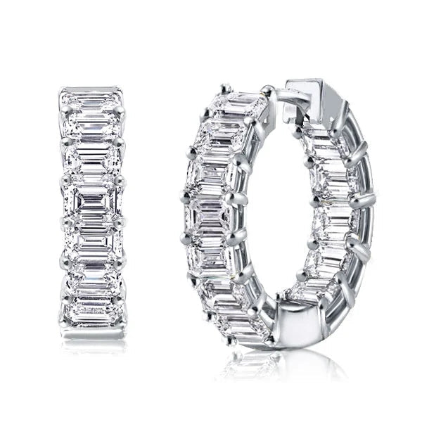 A pair of elegant baguatte huggie earrings made from 925 sterling silver with a white gold finish and adorned with white sapphire stones.