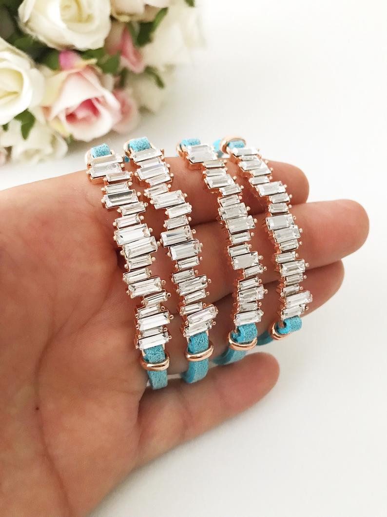 A stylish Baguette Bracelet featuring cubic zirconia stones set in a turquoise leather strap, showcasing a modern and elegant design.