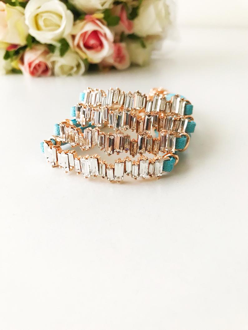 A stylish Baguette Bracelet featuring cubic zirconia stones set in a turquoise leather strap, showcasing a modern and elegant design.