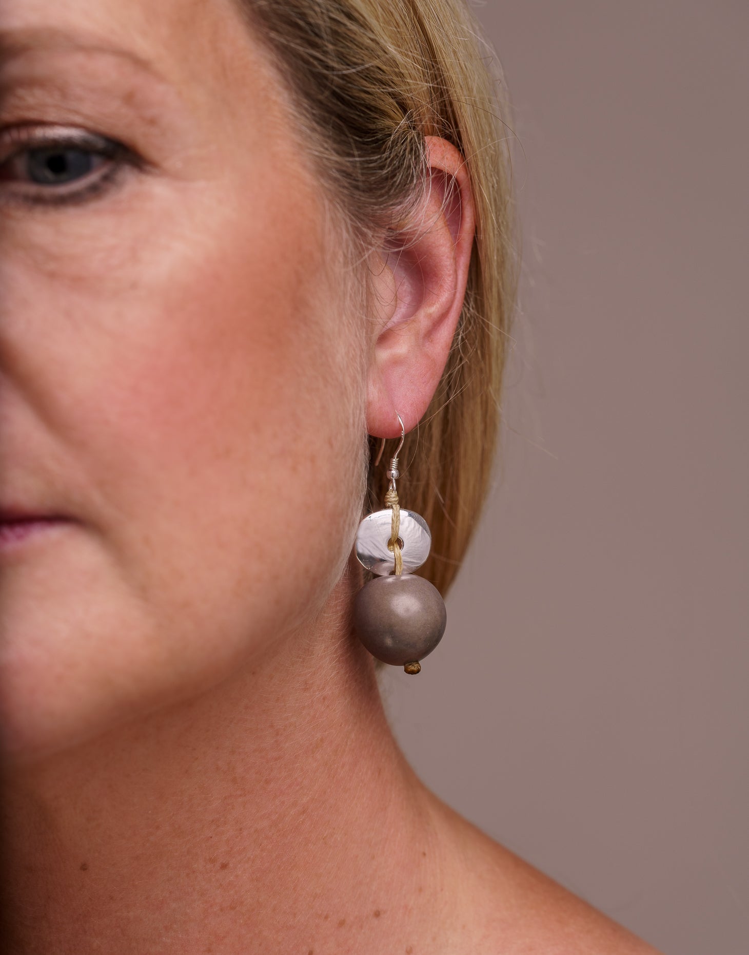 Baiana Bombona Earrings made from Vegetable Ivory and silver, featuring a round shape and sterling silver hooks.