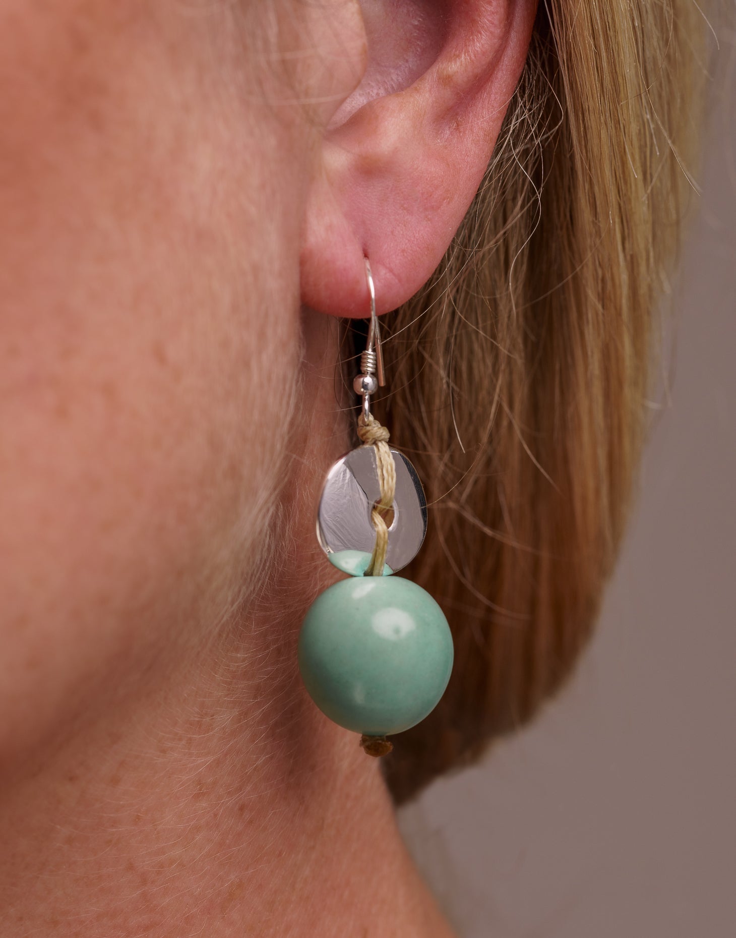 Baiana Bombona Earrings made from Vegetable Ivory and silver, featuring a round shape and sterling silver hooks.