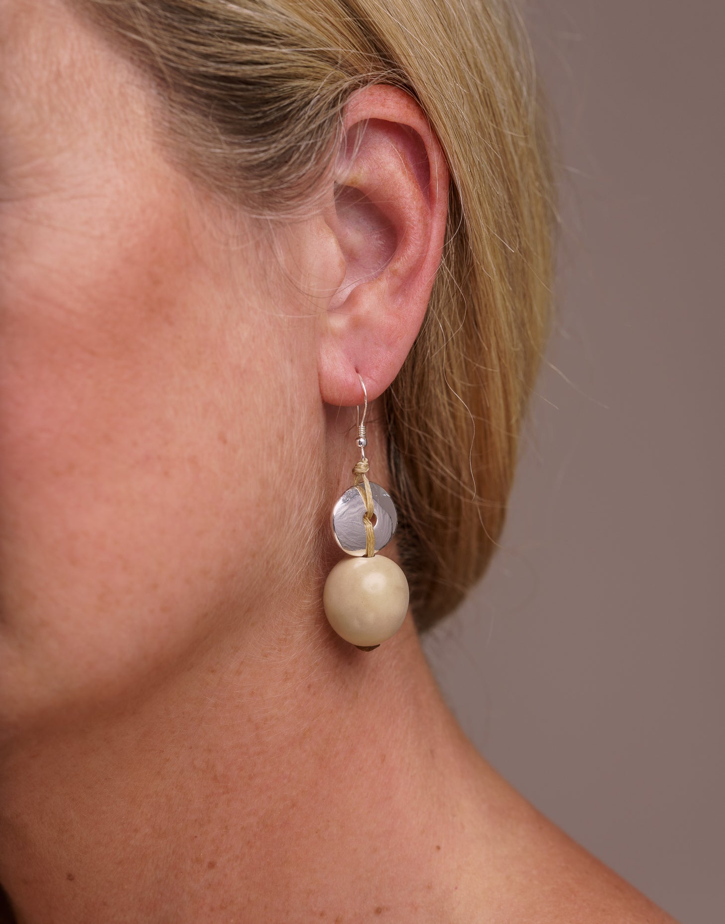 Baiana Bombona Earrings made from Vegetable Ivory and silver, featuring a round shape and sterling silver hooks.