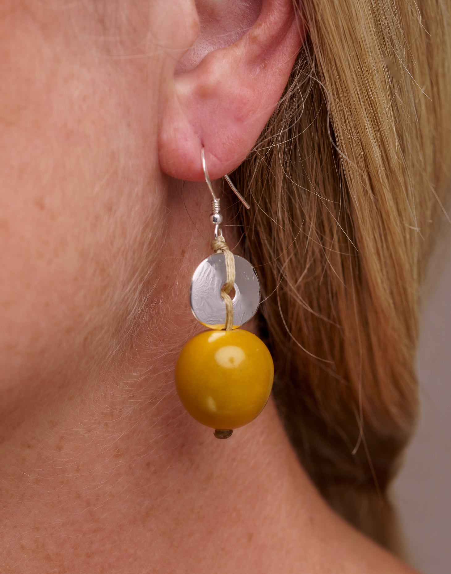 Baiana Bombona Earrings made from Vegetable Ivory and silver, featuring a round shape and sterling silver hooks.