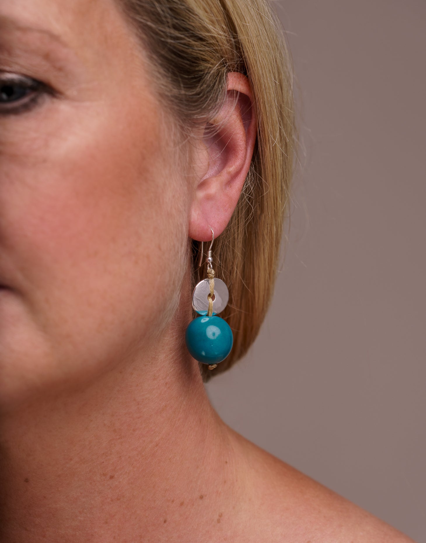 Baiana Bombona Earrings made from Vegetable Ivory and silver, featuring a round shape and sterling silver hooks.