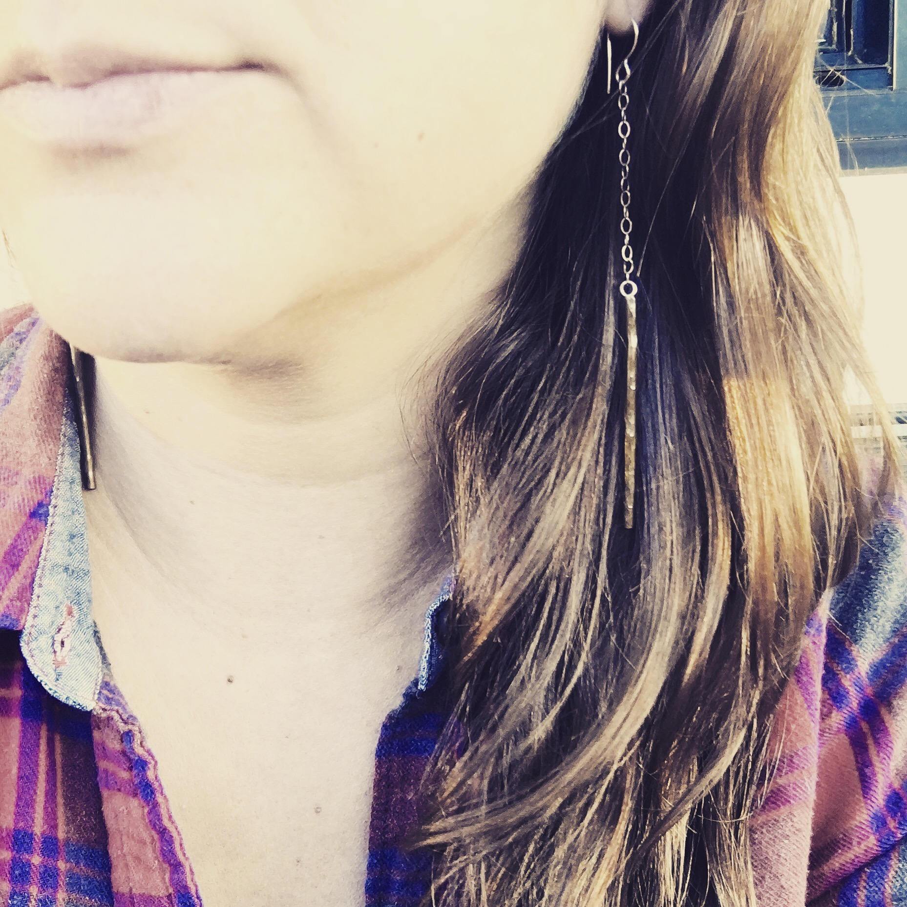 A pair of handmade Balance Earrings featuring rustic textured wire and a lightweight cable chain, available in various finishes.