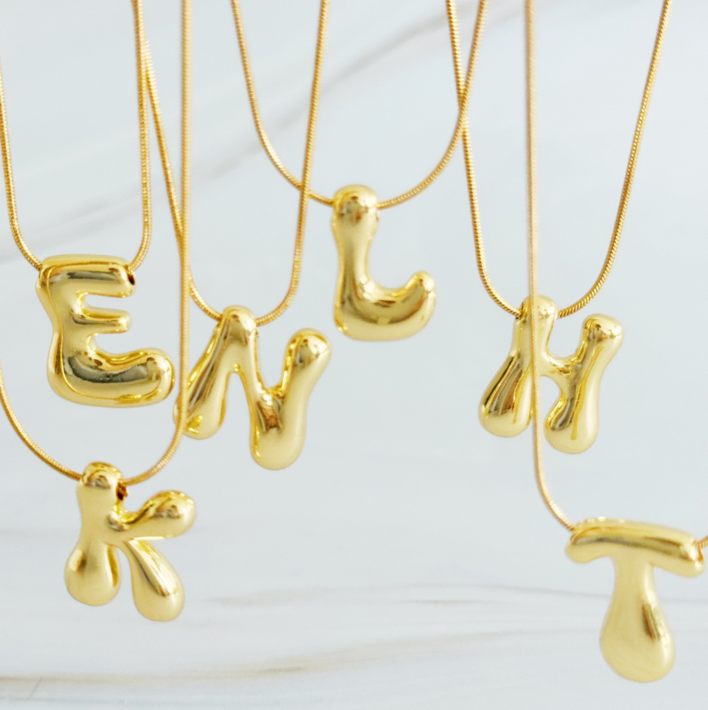 A stylish Balloon Letter Initial Necklace featuring a gold plated initial pendant on a delicate chain.