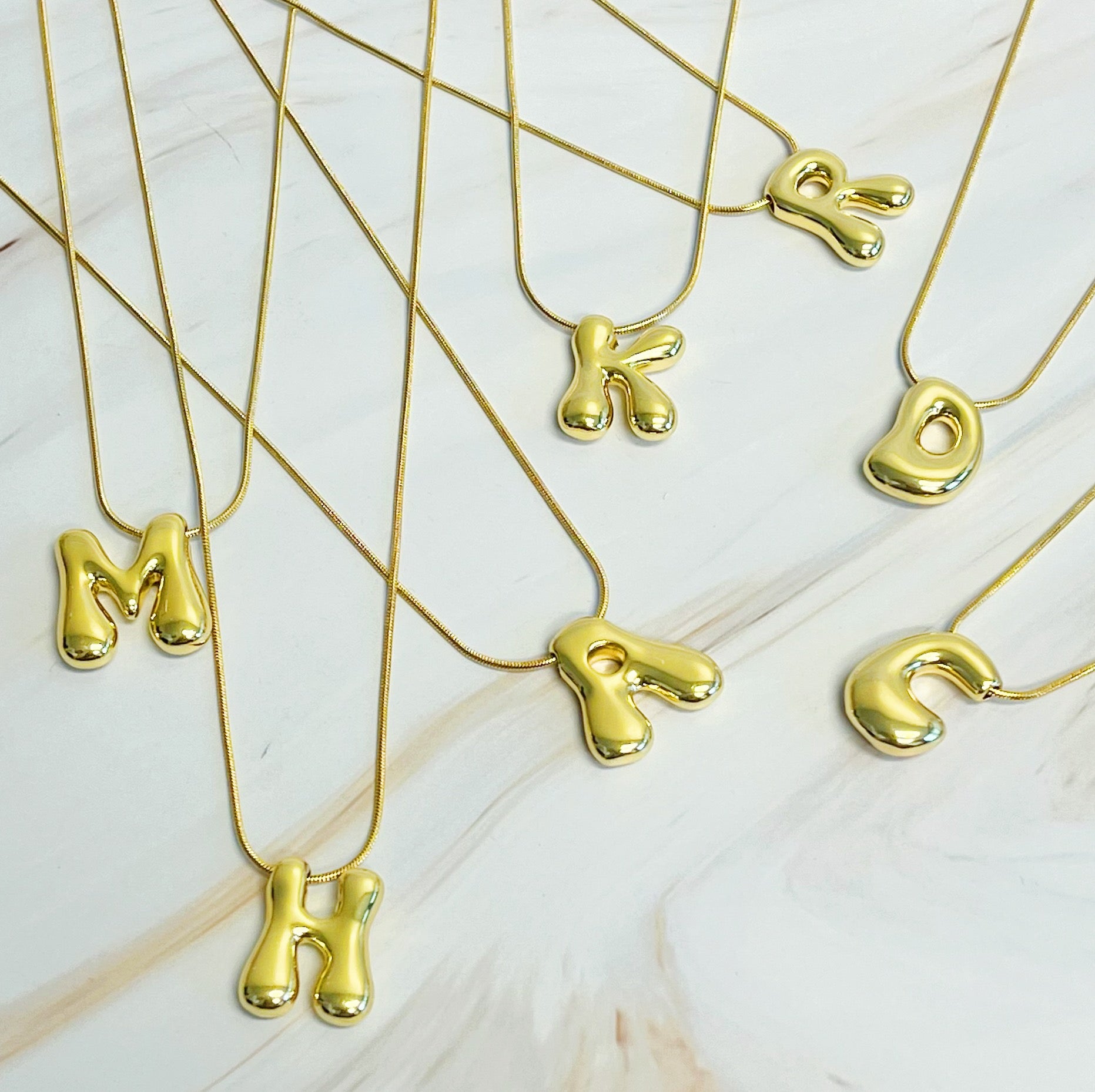 A stylish Balloon Letter Initial Necklace featuring a gold plated initial pendant on a delicate chain.