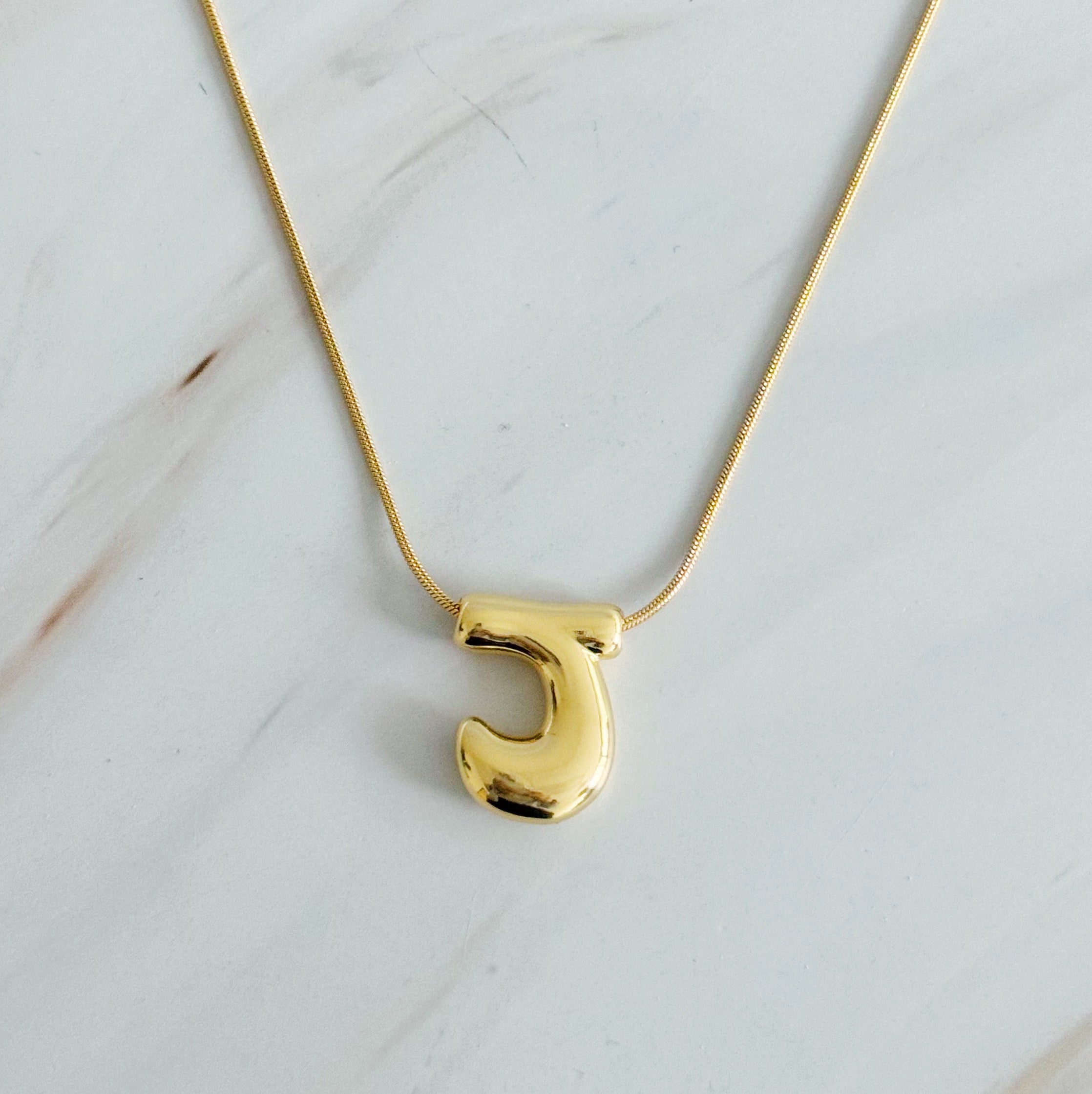 A stylish Balloon Letter Initial Necklace featuring a gold plated initial pendant on a delicate chain.