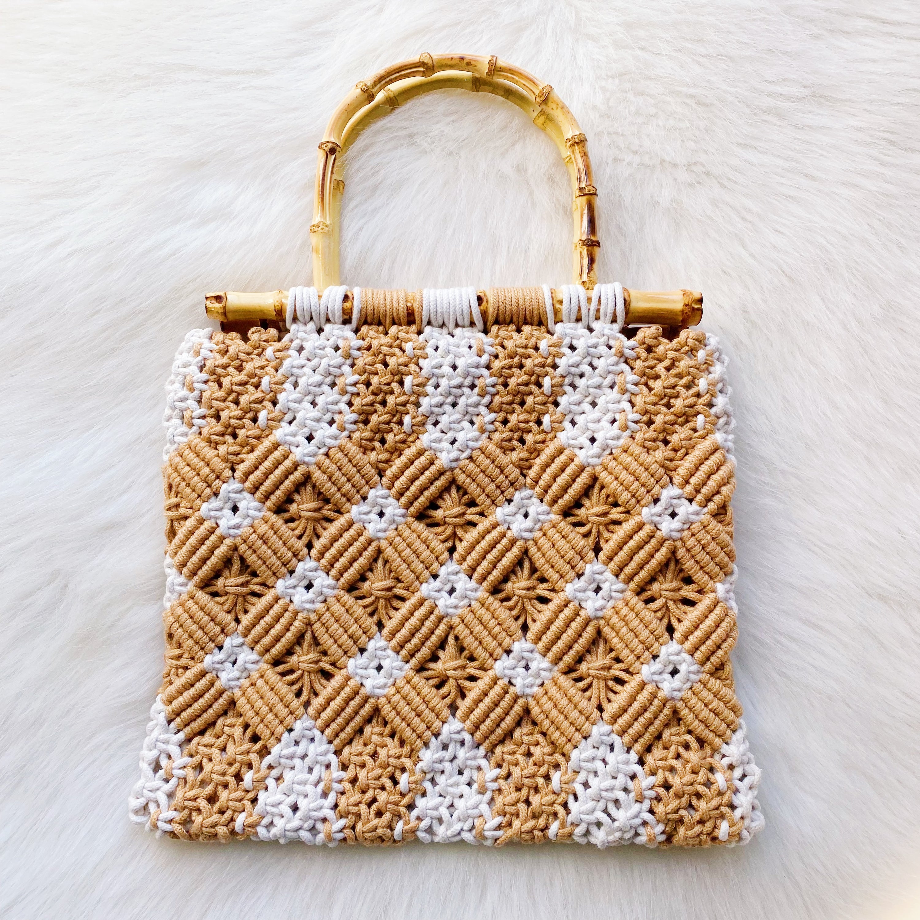 Bamboo Babe Tote featuring elegant bamboo handles and luxurious woven material in neutral colors.