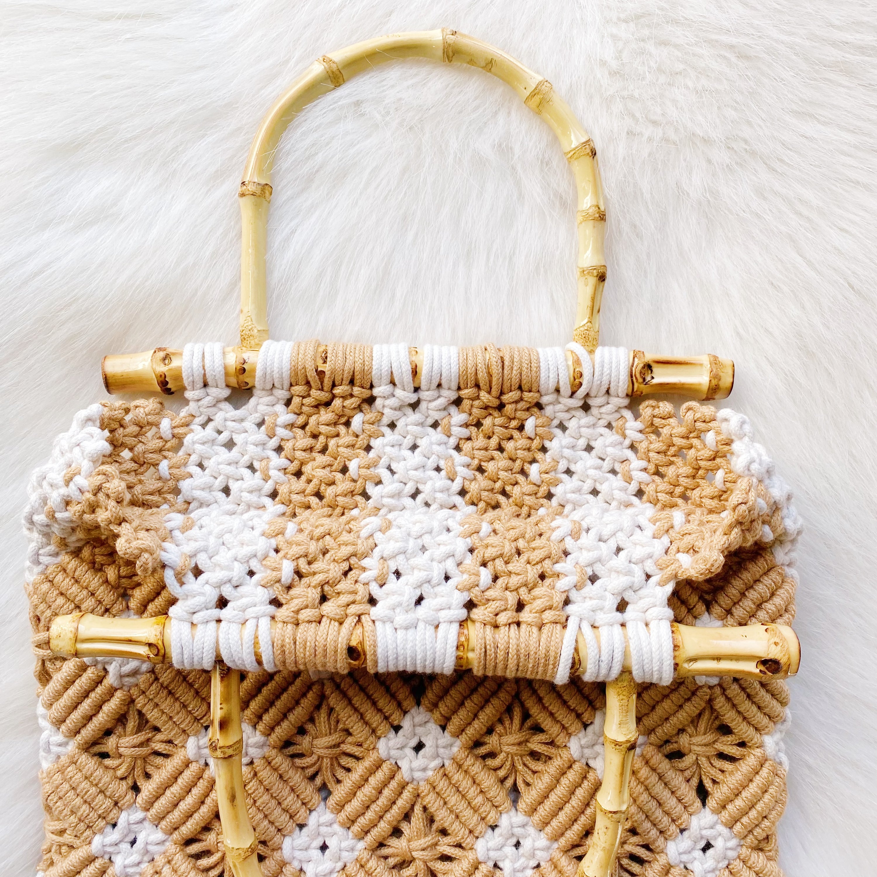 Bamboo Babe Tote featuring elegant bamboo handles and luxurious woven material in neutral colors.