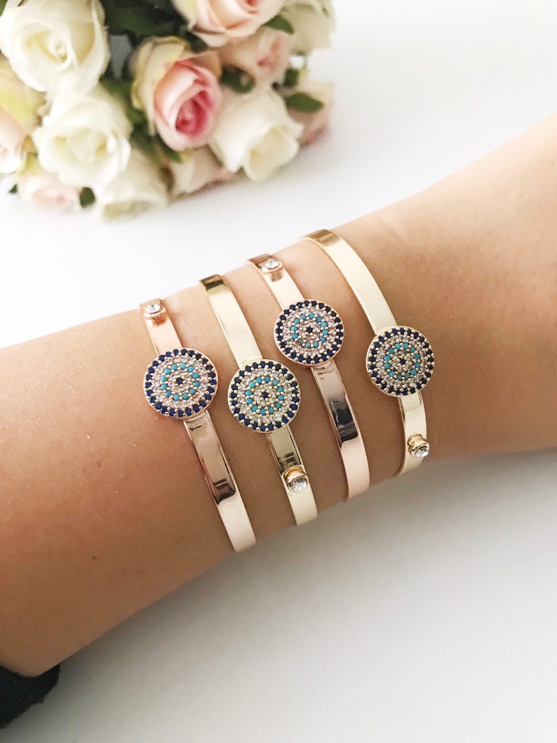 Rose gold Evil Eye Cuff Bracelet featuring a movable oval charm and hamsa hand design, handmade with stainless steel.