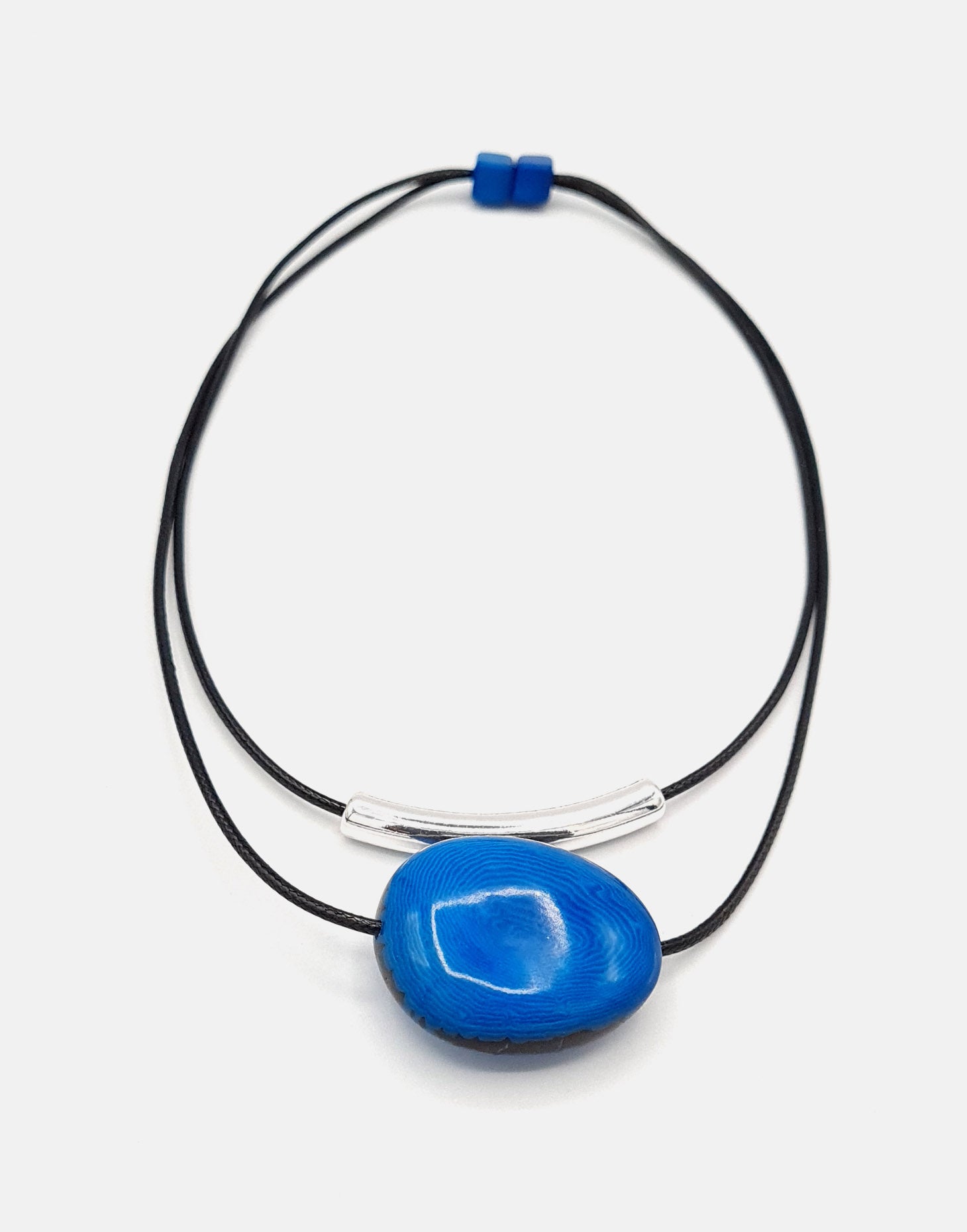 Barra Seed Necklace featuring a silver plated tube and flattened tagua nut, elegantly designed for versatile wear.