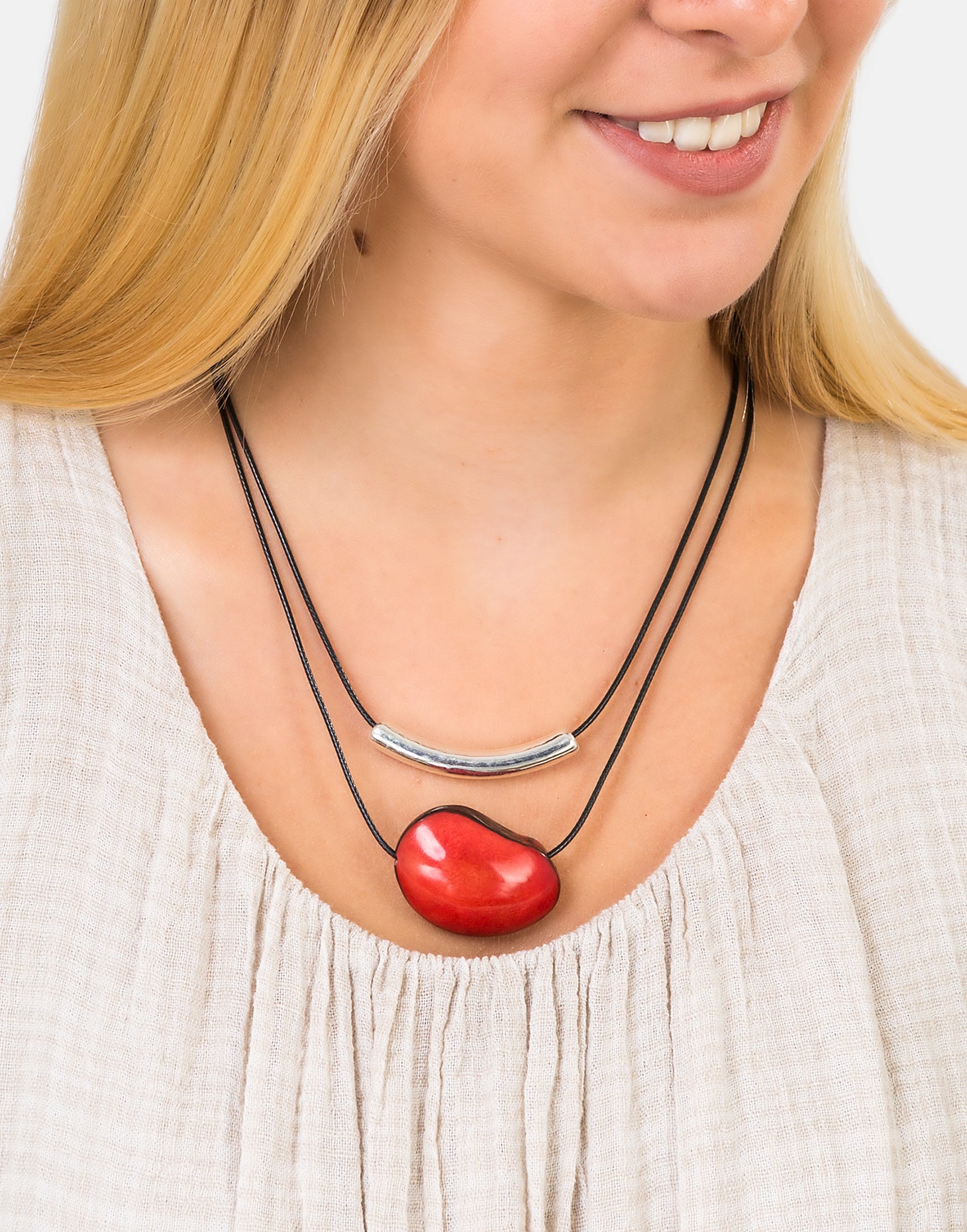 Barra Seed Necklace featuring a silver plated tube and flattened tagua nut, elegantly designed for versatile wear.