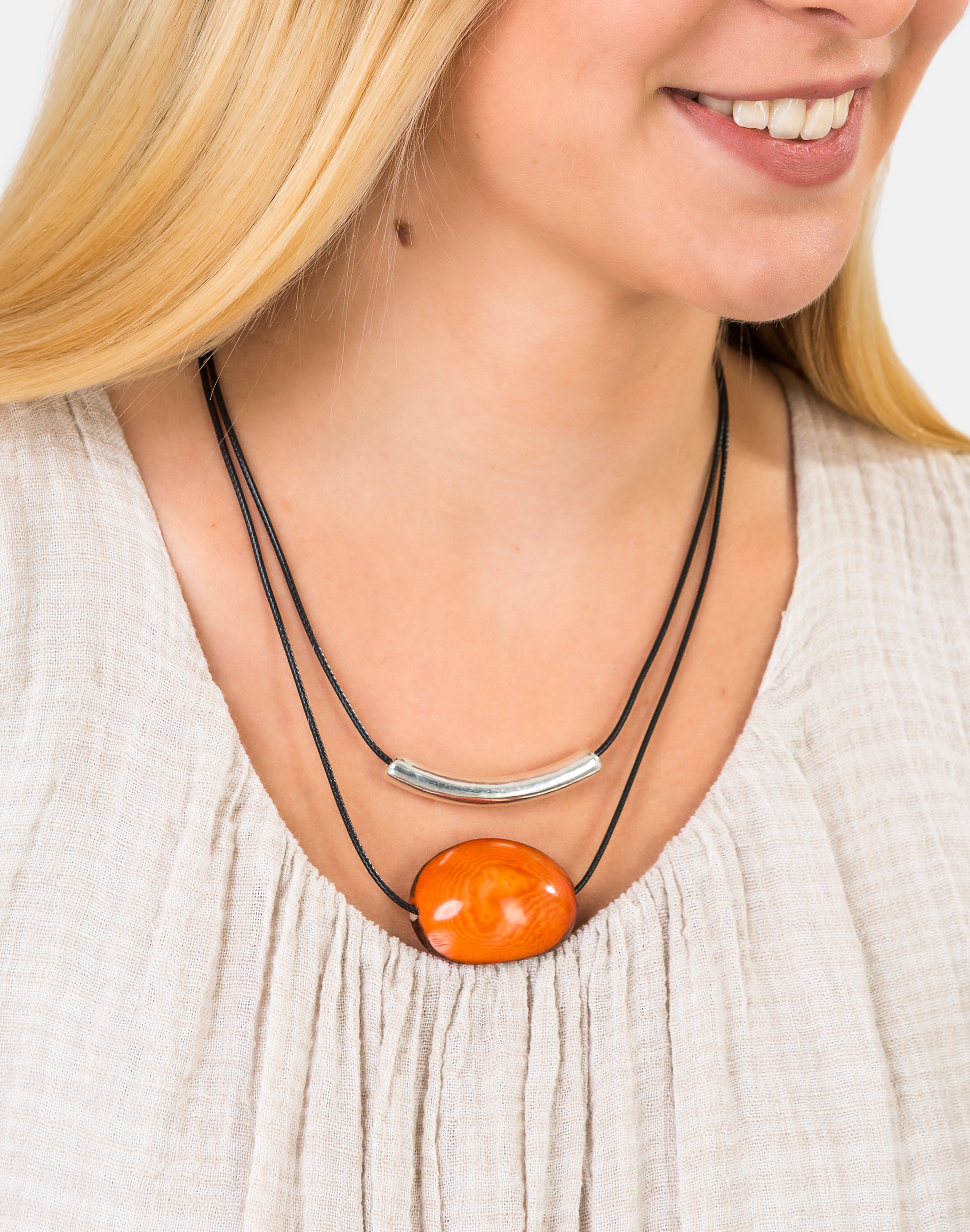 Barra Seed Necklace featuring a silver plated tube and flattened tagua nut, elegantly designed for versatile wear.