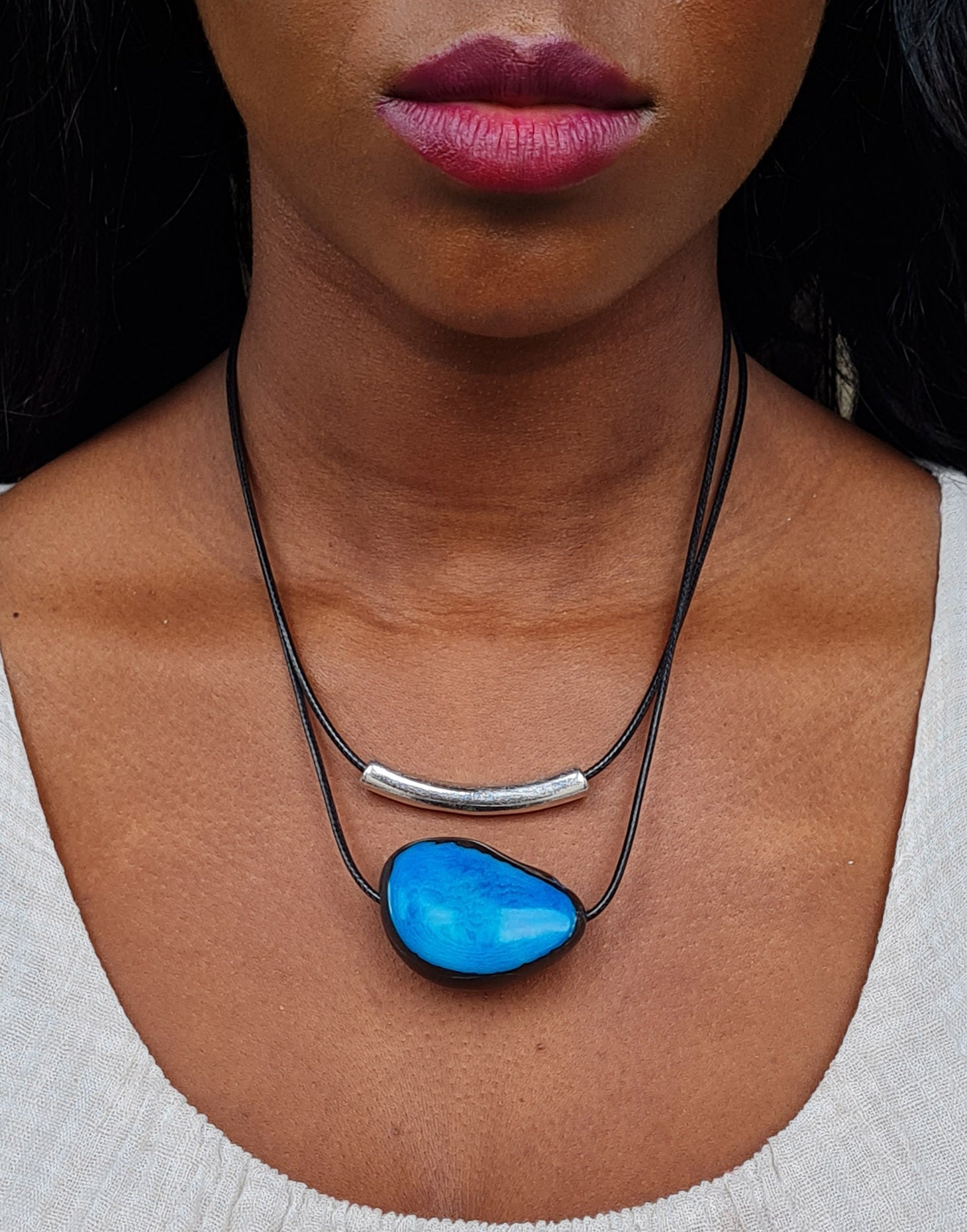 Barra Seed Necklace featuring a silver plated tube and flattened tagua nut, elegantly designed for versatile wear.