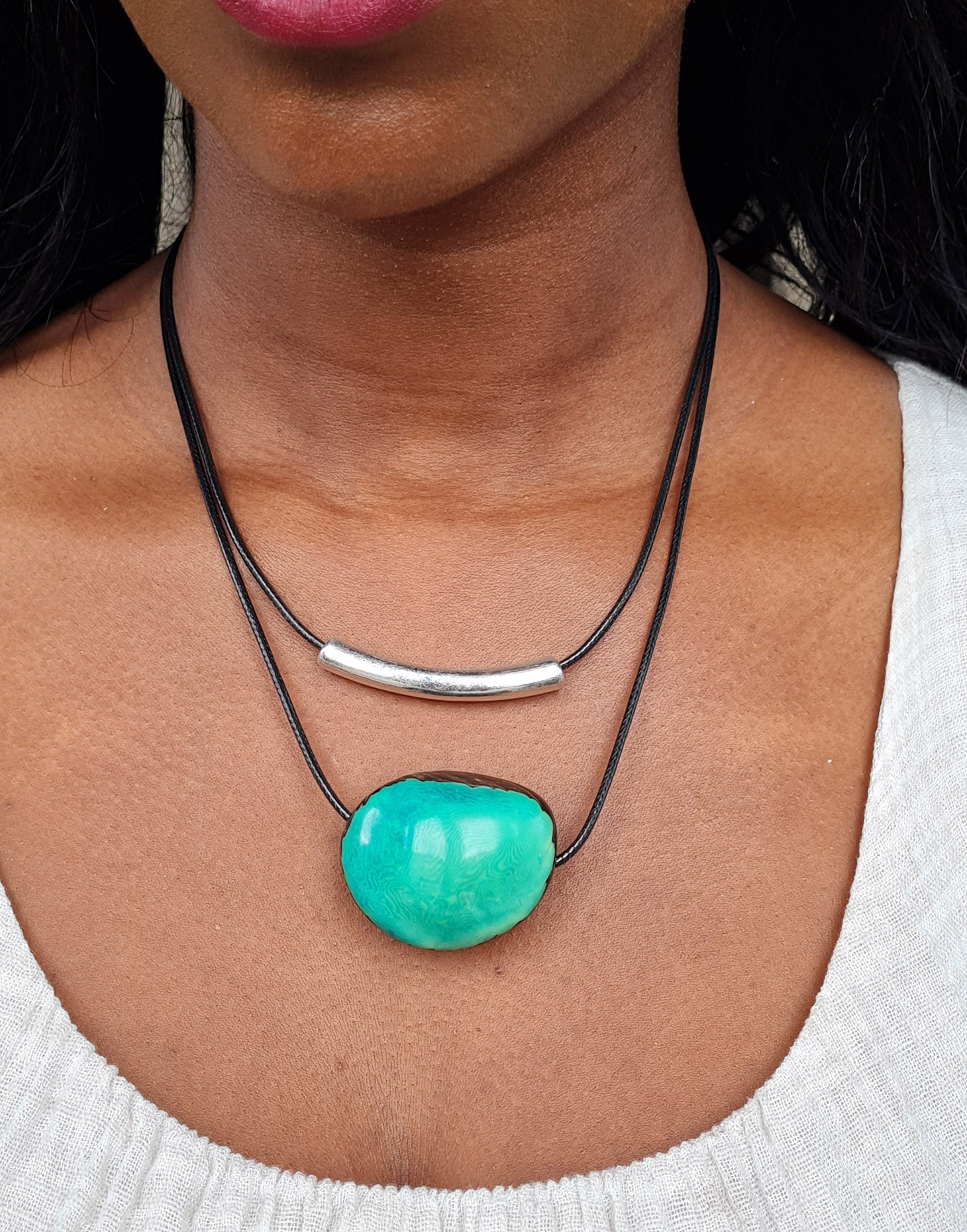 Barra Seed Necklace featuring a silver plated tube and flattened tagua nut, elegantly designed for versatile wear.