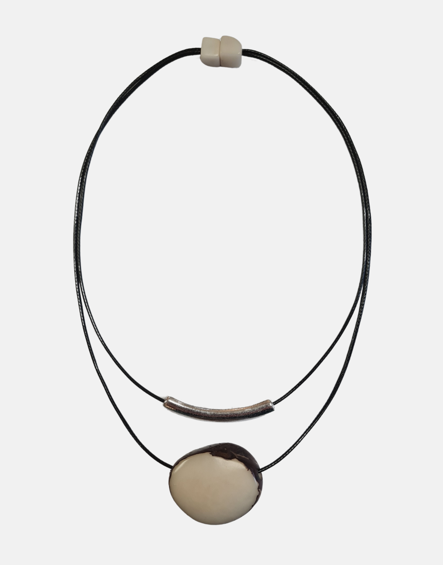 Barra Seed Necklace featuring a silver plated tube and flattened tagua nut, elegantly designed for versatile wear.