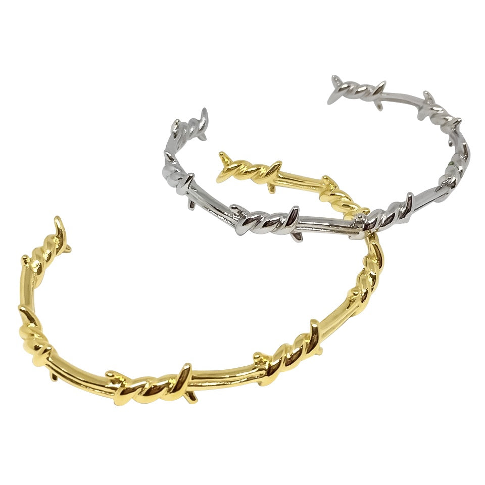 A stylish Barbed Wire Open-Cuff Bangle made of 18ct gold plated titanium steel, showcasing its unique design and adjustable fit.