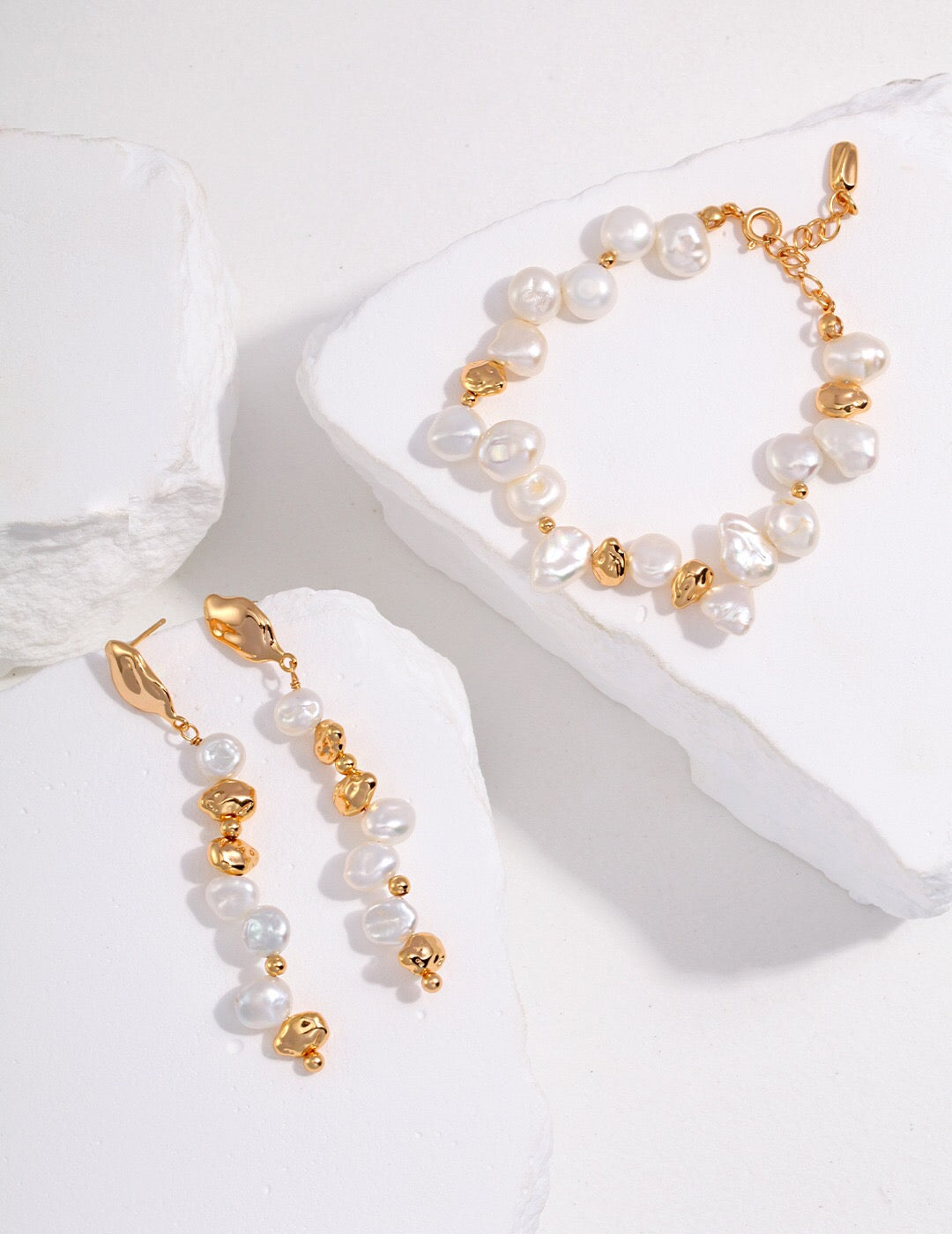 A handcrafted Baroque Pearl Beaded Bracelet featuring natural pearls and gold vermeil, elegantly displayed on a soft surface.