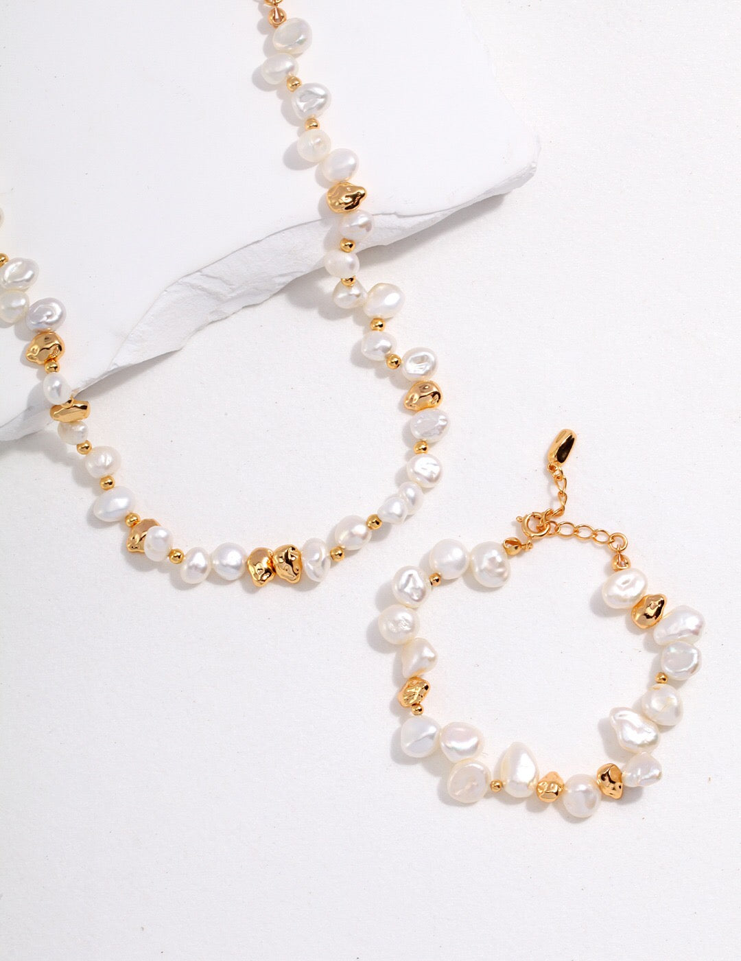 A handcrafted Baroque Pearl Beaded Bracelet featuring natural pearls and gold vermeil, elegantly displayed on a soft surface.