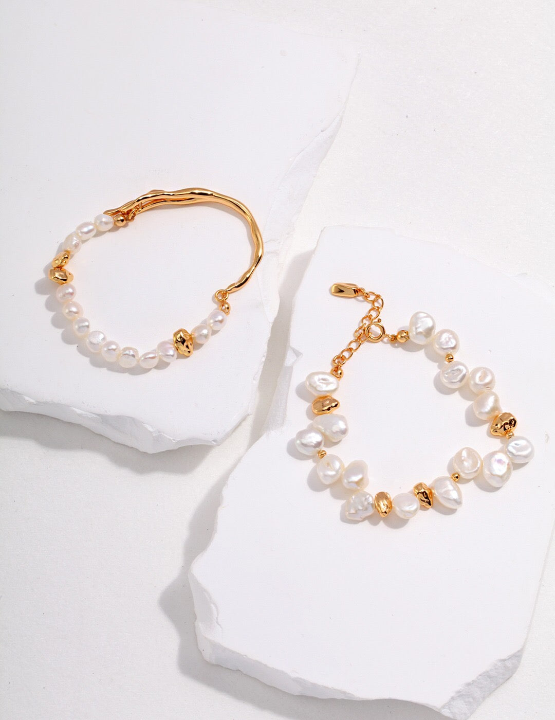 A handcrafted Baroque Pearl Beaded Bracelet featuring natural pearls and gold vermeil, elegantly displayed on a soft surface.