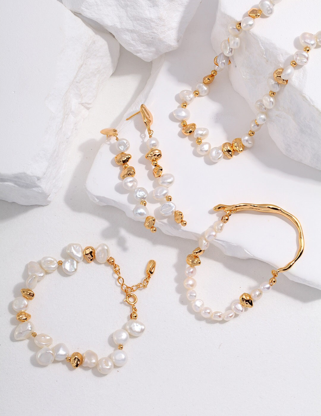 A handcrafted Baroque Pearl Beaded Bracelet featuring natural pearls and gold vermeil, elegantly displayed on a soft surface.