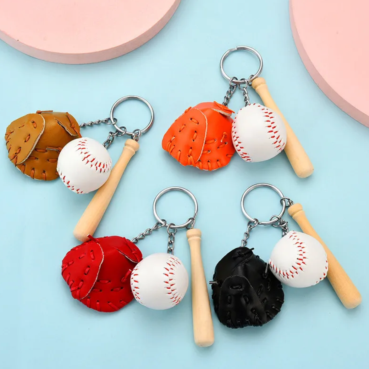 A colorful keychain featuring a miniature baseball bat, ball, and faux leather glove in various colors.