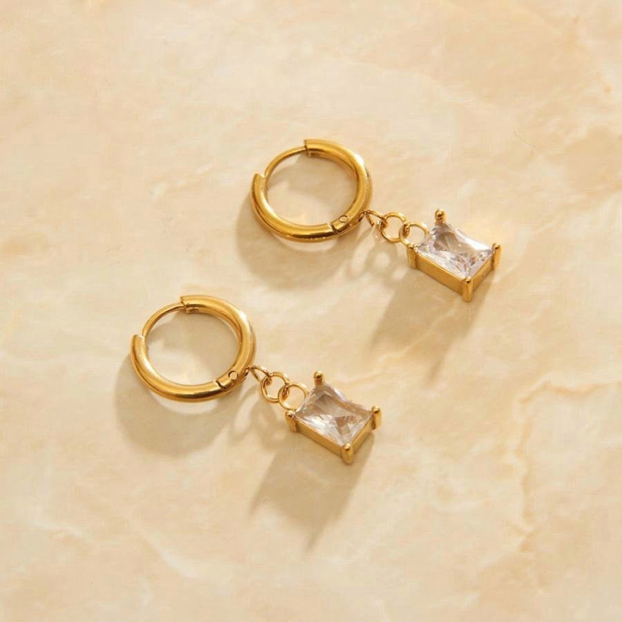 Basil Chunky Crystal Charm Hoops featuring a polished design and dangling crystal charm, perfect for stylish layering.