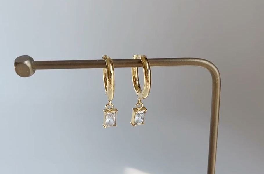 Basil Chunky Crystal Charm Hoops featuring a polished design and dangling crystal charm, perfect for stylish layering.