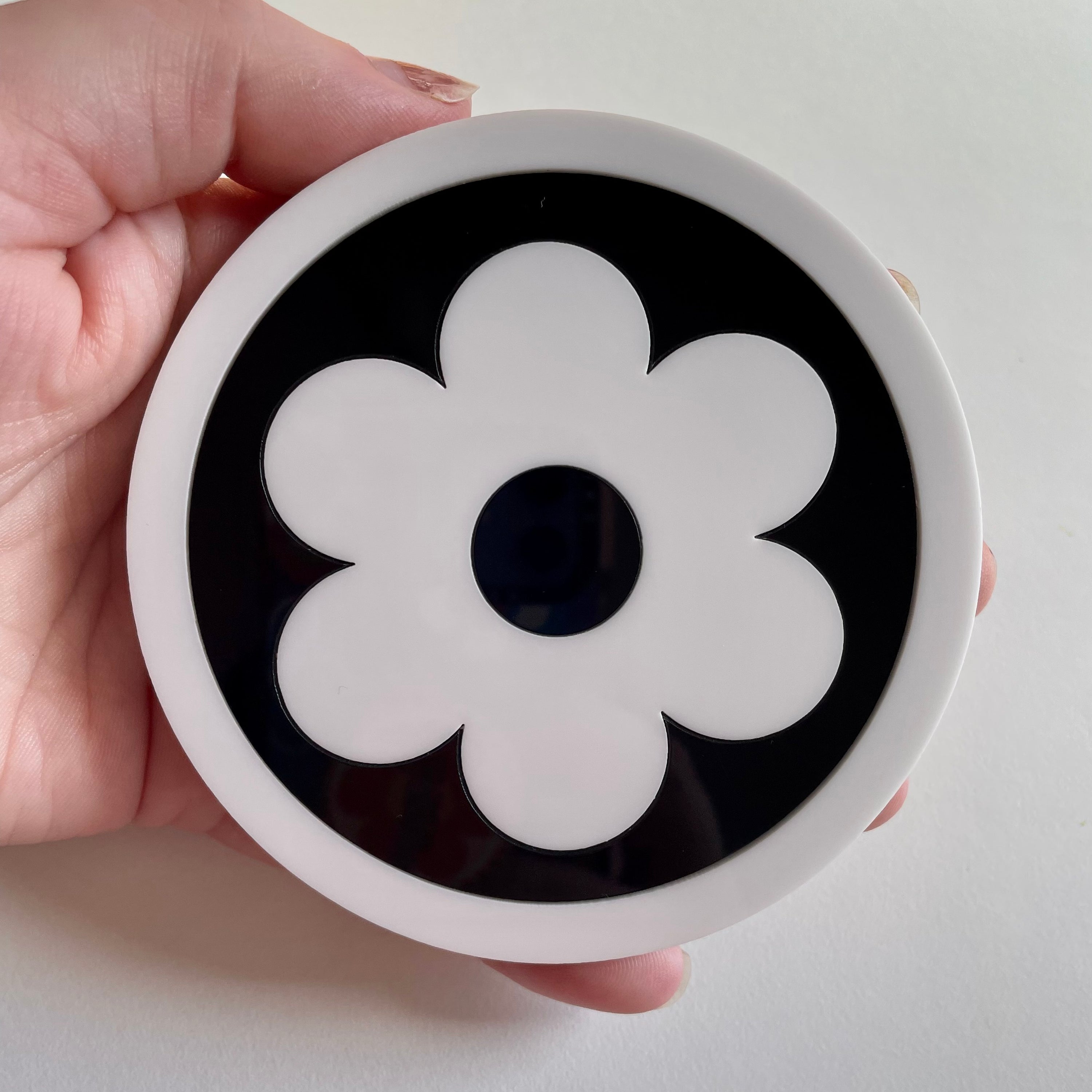 A stylish Bazaar Coaster featuring laser-cut acrylic design with a cork base, measuring 9.5cm in diameter.