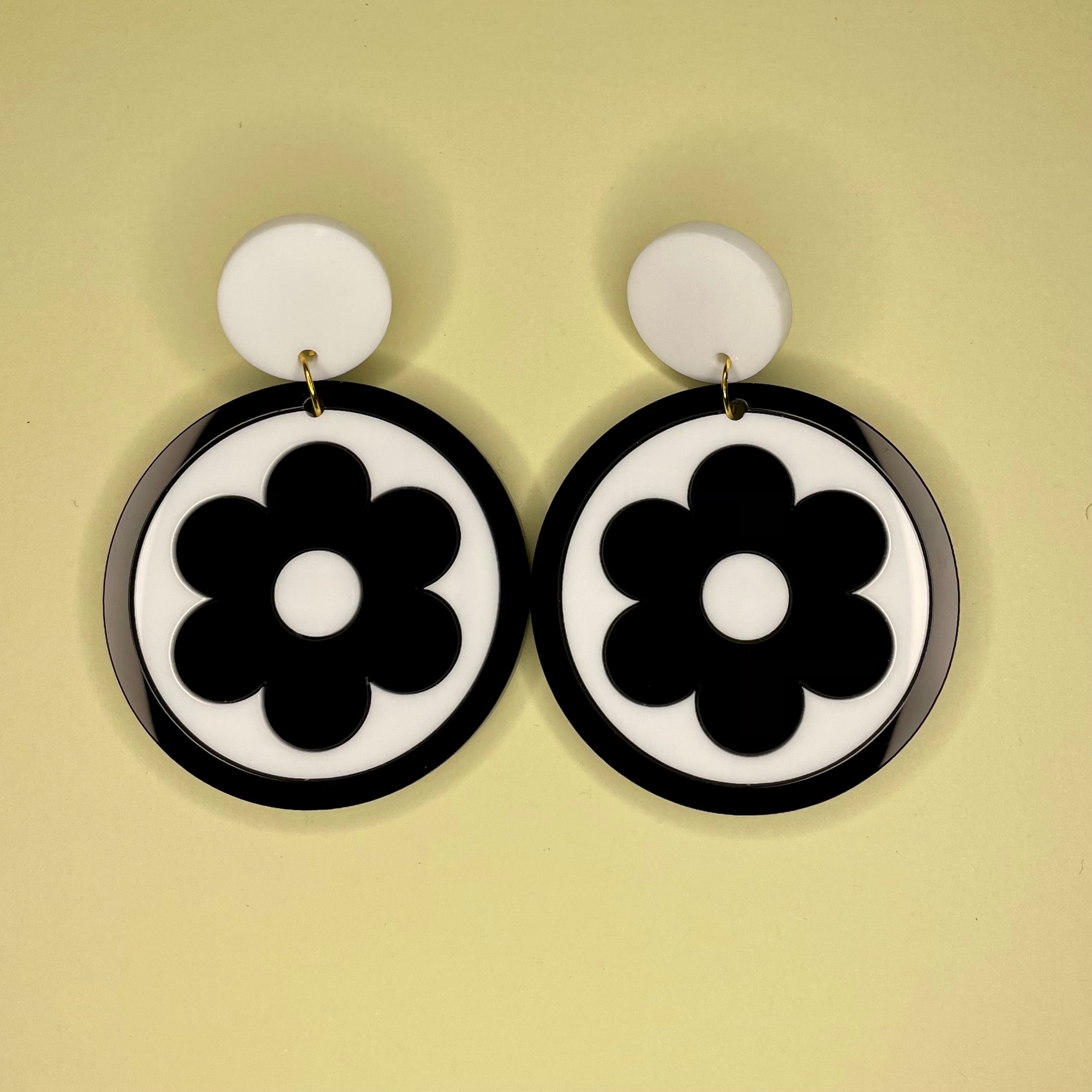 Stylish Bazaar Earrings featuring laser-cut acrylic design, inspired by 1960s fashion, available in clip-on style.