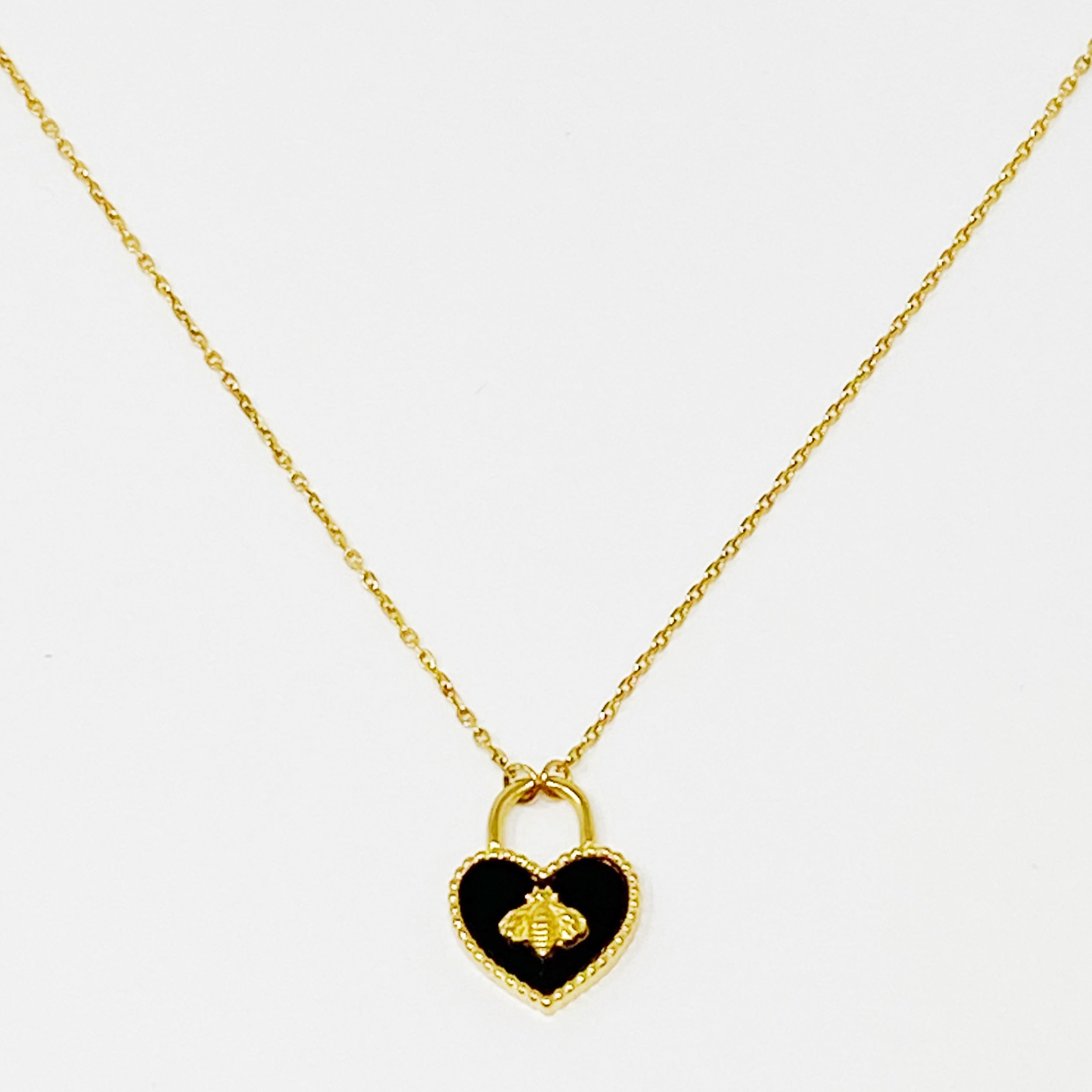 Bee Heartful Necklace featuring a heart pendant with a gold bee centerpiece on a gold plated chain.