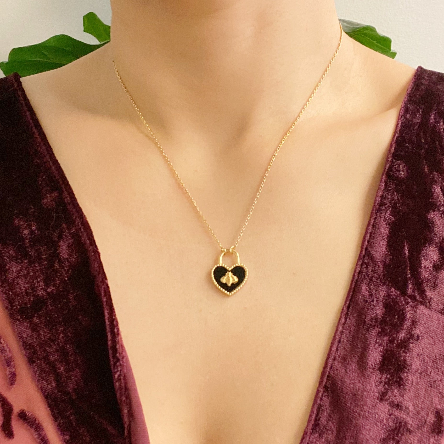 Bee Heartful Necklace featuring a heart pendant with a gold bee centerpiece on a gold plated chain.