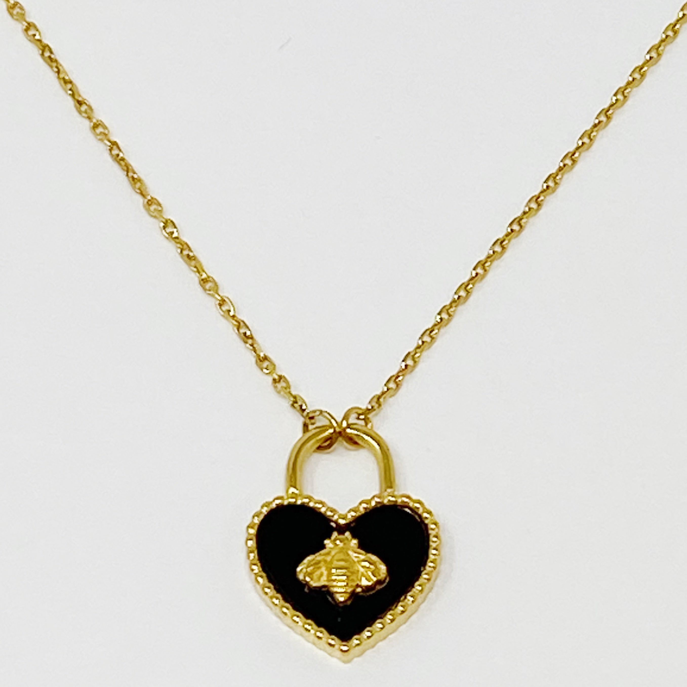 Bee Heartful Necklace featuring a heart pendant with a gold bee centerpiece on a gold plated chain.