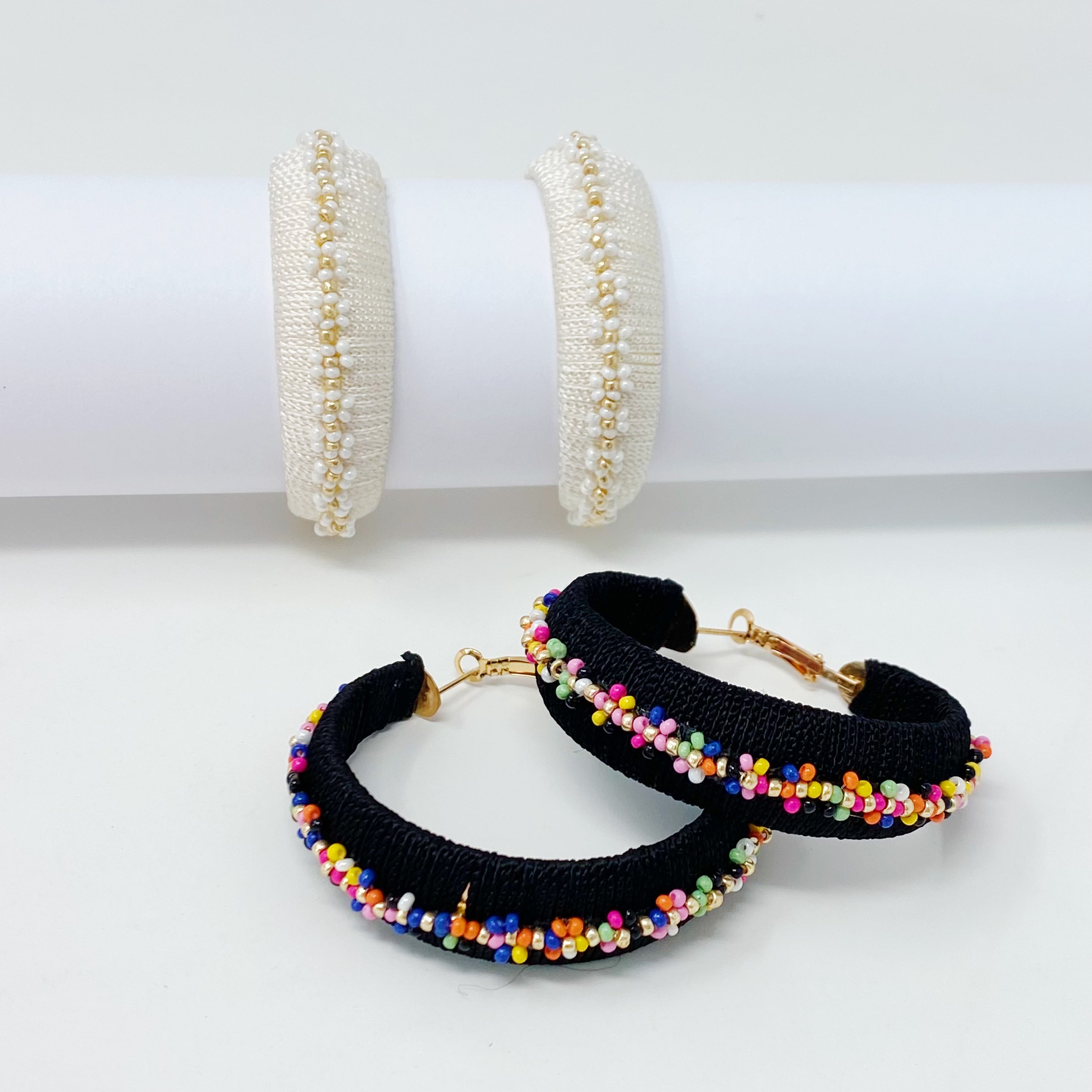 Elegant beaded hoop earrings with flower detailing, showcasing a bold yet classy design.