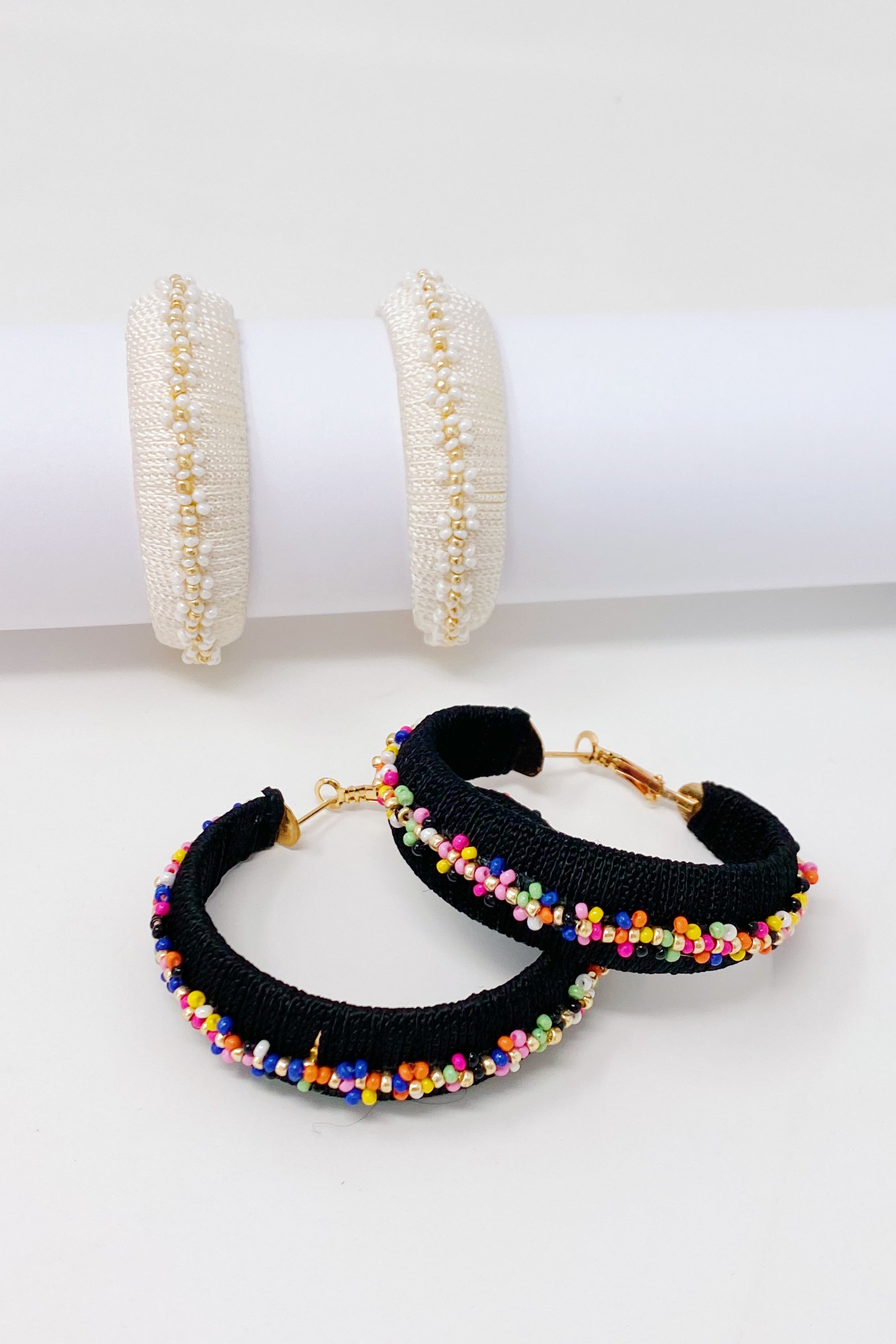 Elegant beaded hoop earrings with flower detailing, showcasing a bold yet classy design.