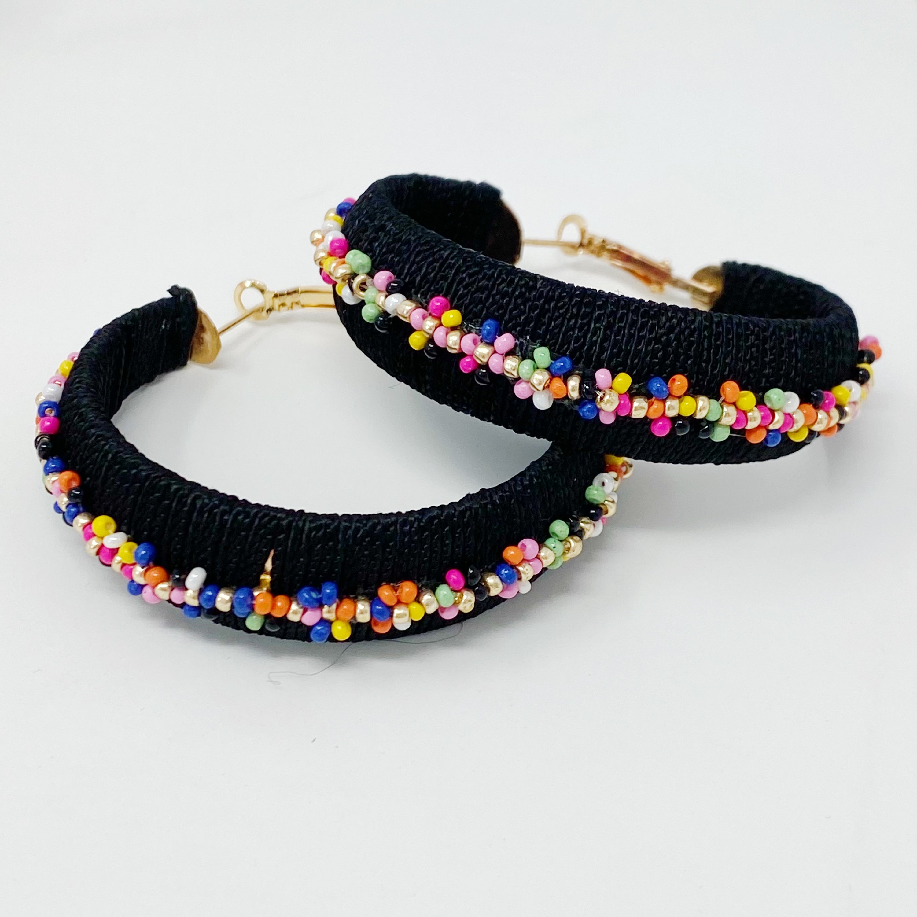 Elegant beaded hoop earrings with flower detailing, showcasing a bold yet classy design.